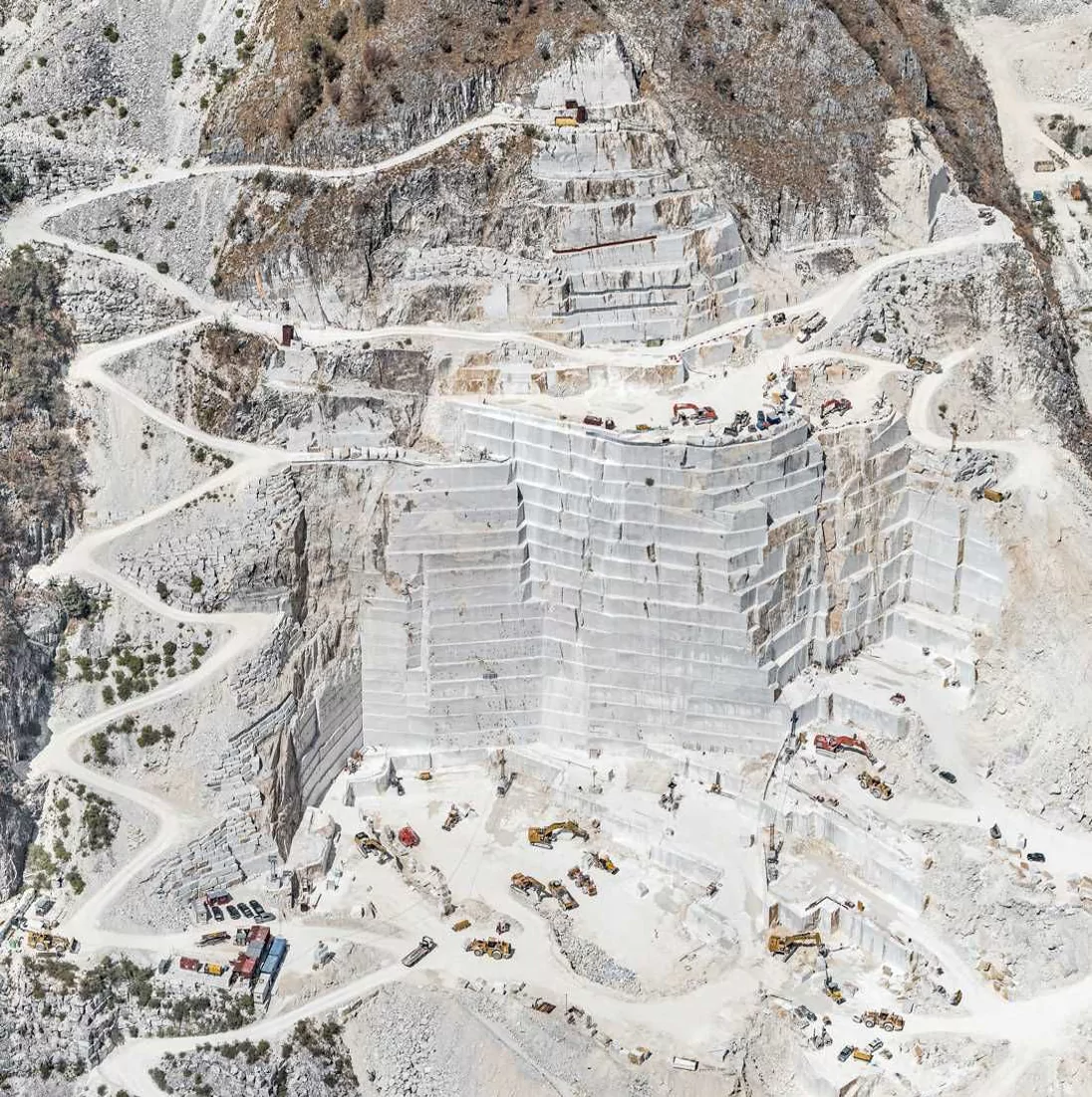 Aerial view of a marble quarry being worked in terraced benches